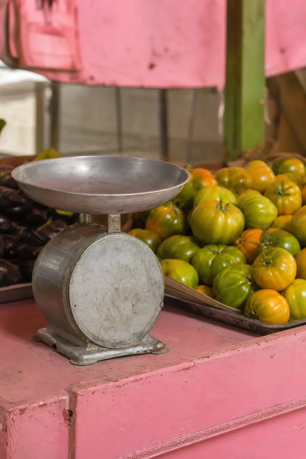 An old mechanical scale pan on a market counter