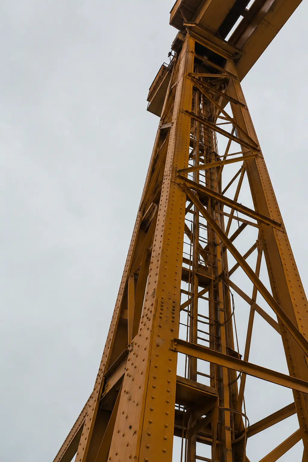 Looking up the leg of an amber gantry crane