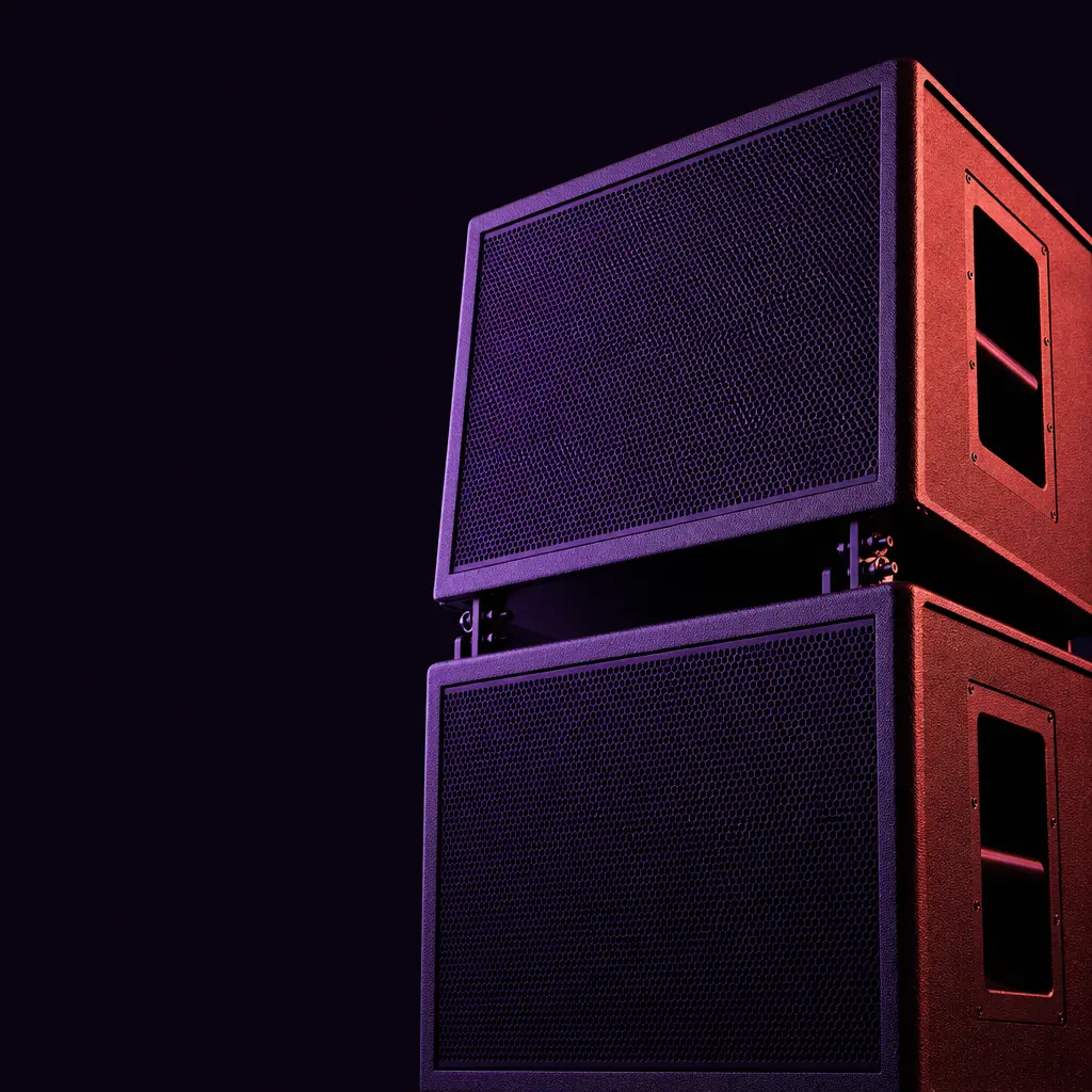 A stack of speaker cabinets lit from one side in violet